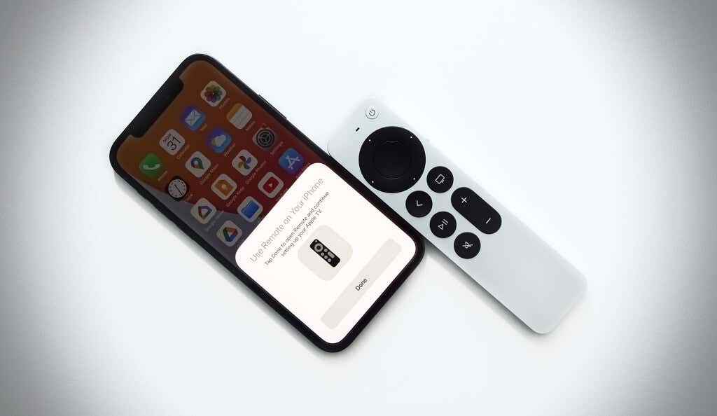 An iPhone and  an Apple TV Remote