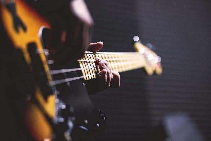 Closeup of someone playing a bass guitar